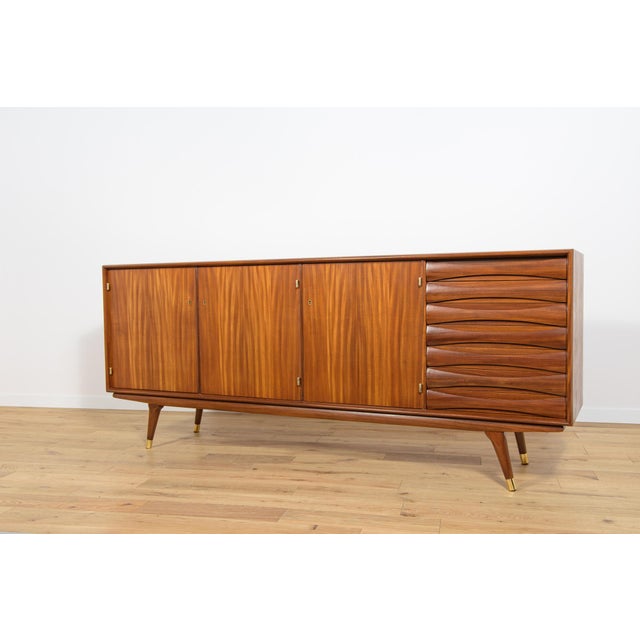 The teak sideboard was designed by Sven Andersen in the 1960s for Sven Andersen's Norwegian factory, Möbelfabrik...
