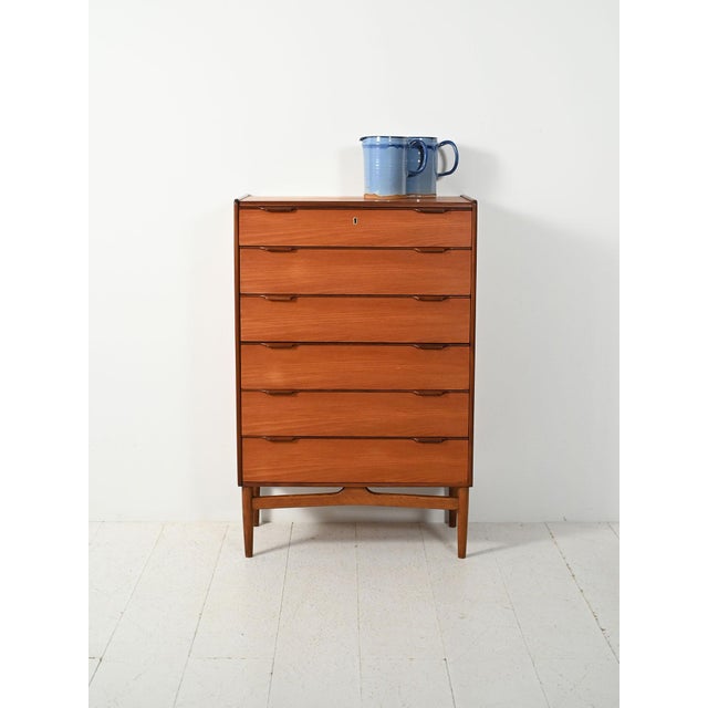 Danish teak chest of drawers from the 1960s, with carved handles and refined color contrasts. Danish teak chest of drawers...