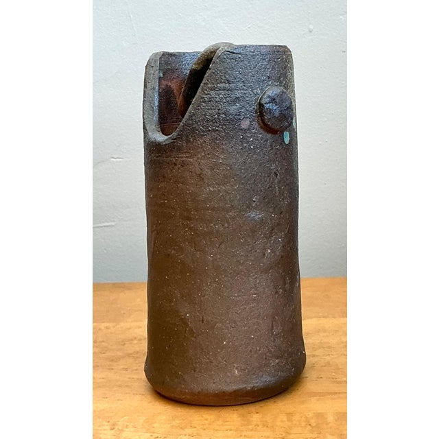 This vintage handcrafted earthenware vessel is a striking expression of mid-century studio pottery, celebrated for its...