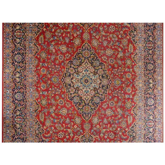 A wonderful early 20th century traditional Persian Kashan rug with a large diamond medallion amidst a field of large-scale...