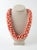 Mid 20th century bold dimensional salmon and white graduated beaded necklace. Measures 27" long, 1" diameter at smallest...