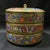 This is a vibrant and exquisitely decorated porcelain lidded jar, featuring intricate hand-painted floral motifs in the...