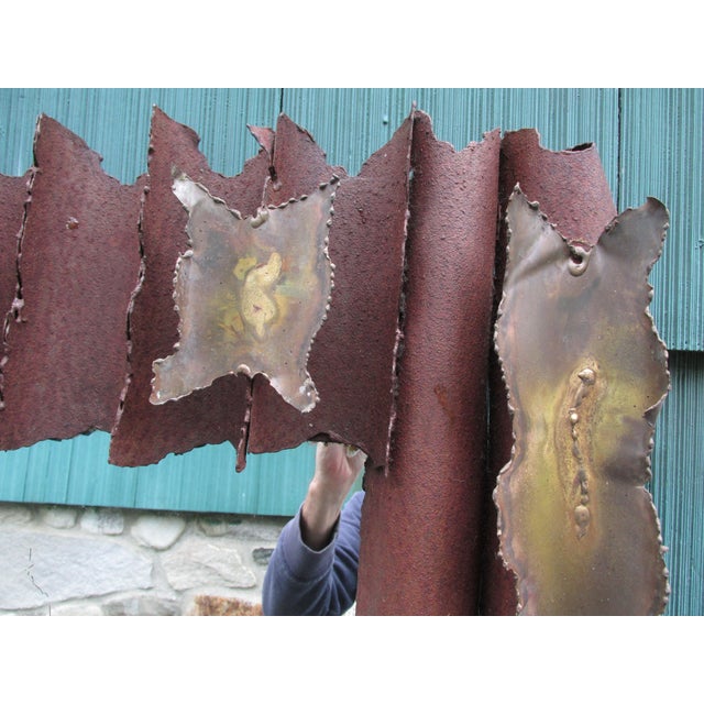Distressed Brutalist Style torch cut steel wall mirror attributed to Tom Greene, circa 1970. This rusted and oxidized hulk...