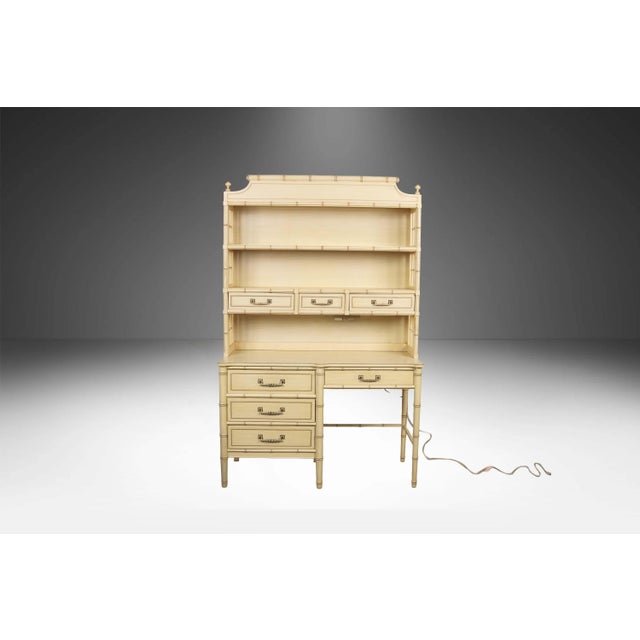 Attractive vintage faux bamboo Henry Link Bali Hai desk with light up top hutch circa 1960s. Crafted by the Henry Link...