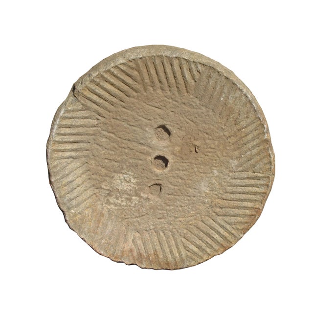 This top of a watermill stone was retrieved from the northern part of China. It was originally used for grinding grains....