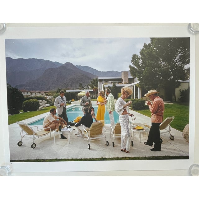 "Poolside Chat", Palm Springs 1970, Limited Edition 1/150, 30" x 40" C-Print by Slim Aarons A vibrant, expanded view of...
