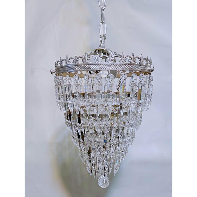 Decorative upside down layered cake chandelier with ornate silver rim and 30% leaded hand cut spear drop crystals. Rewired...