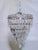 Decorative upside down layered cake chandelier with ornate silver rim and 30% leaded hand cut spear drop crystals. Rewired...