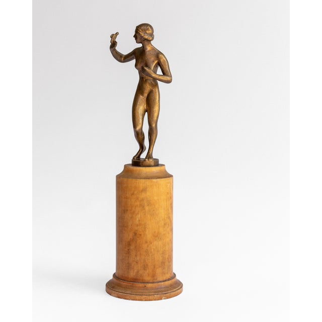 A rare small bronze by Swedish sculptor Tore Strindberg (1882–1968), depicting a nude female figure reaching gracefully...