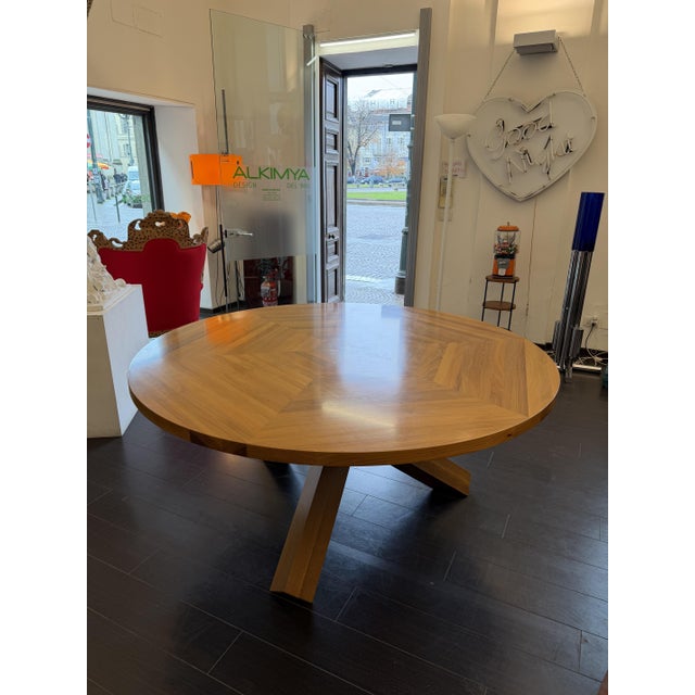 Iconic table model La rotonda by Mario Bellini produced by Cassina in the 70s, walnut and cherry wood with contrasting...