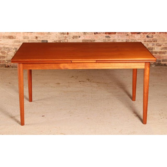 Large danish mid century extending teak dining table by am mobler, circa 1960s. 2 extension leaves stored underneath....