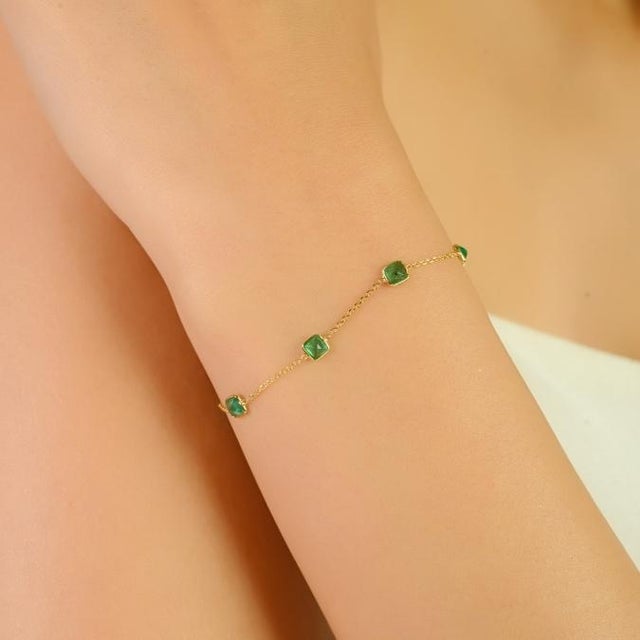 This dainty station chain bracelet features 8 natural princess-cut emeralds totaling 1.4 carats, set in rich 18K yellow...