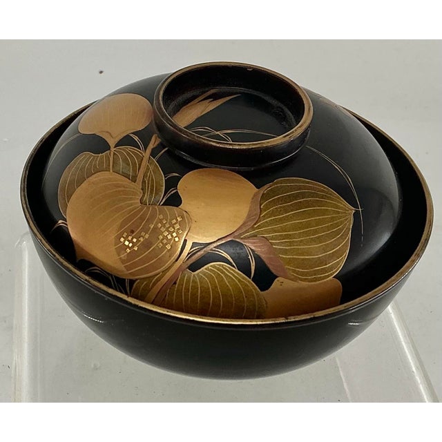 Beautiful Japanese laquer bowl and lid hand decorated in different shades of gold. Turtles depicted on the bottom bowl,...