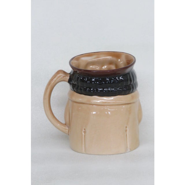 This charming character mug is made of porcelain. This interesting toby jug is titled Shorter and Son old Staffs. This...