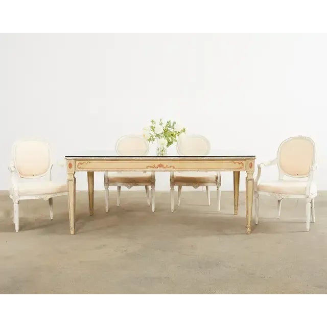 Charming set of four French dining armchairs made in the grand Louis XVI taste. Crafted from beech and featuring a Swedish...