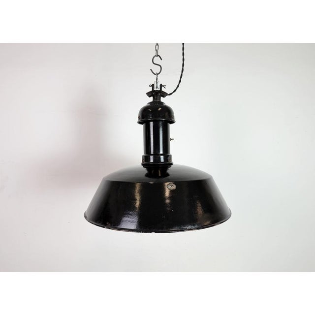 Vintage Industrial black enamel pendant lamp in Bauhaus style. Used in factories in former Czechoslovakia during the...