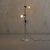 This mid-century French floor lamp embodies the era’s embrace of industrial minimalism. Two perforated metal shades,...
