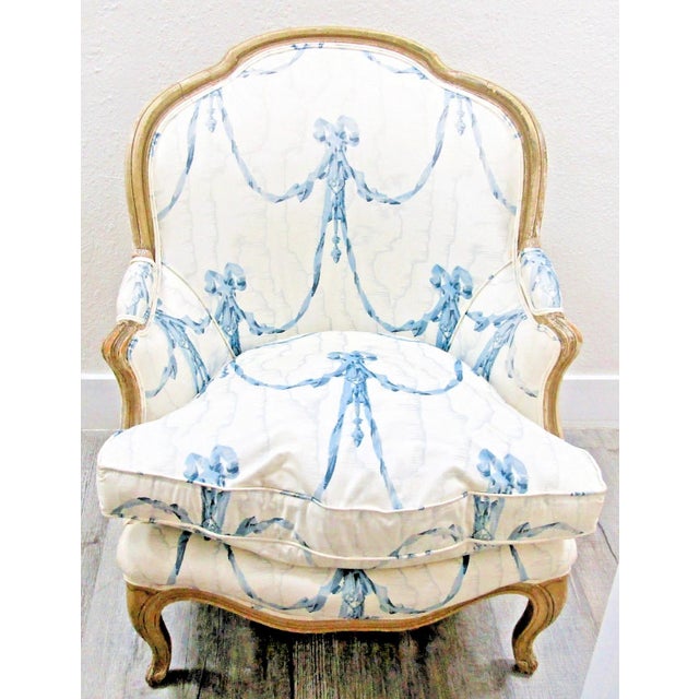 The Antique Framed French Louis XV Style Bergère Chair is a stunning piece of vintage furniture upholstered in luxurious...