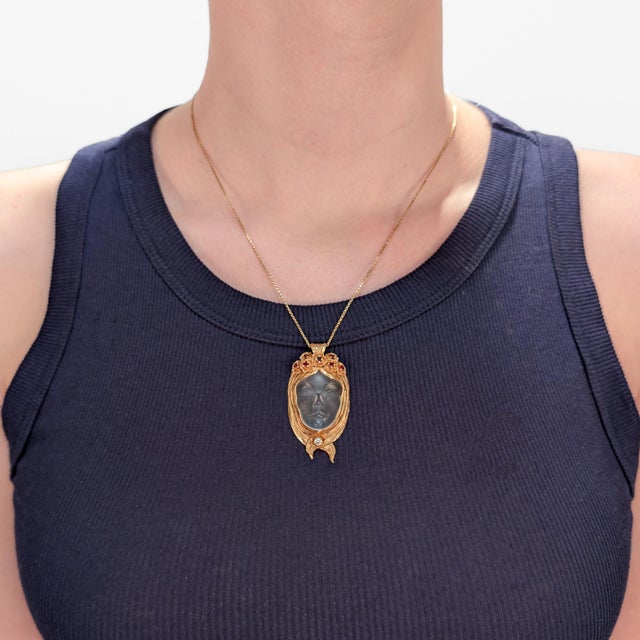 A fine vintage signed multi-gemstone figural pendant for a necklace. By Walter Bauscher. In 14 karat yellow gold. With a...