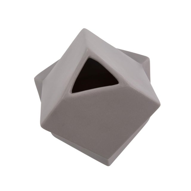 The shapes of these vases were created and inspired by the cubist movement in the art world. A matte gray finish...