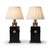 Pair of Art Deco-style table lamps dating to the 1940s. Rectangular black lacquered metal bodies sit above square brass...