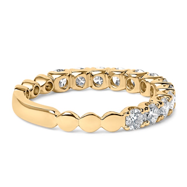 Experience the unending circle of love with this exquisitely crafted wedding band, forged from radiant 14k yellow gold and...