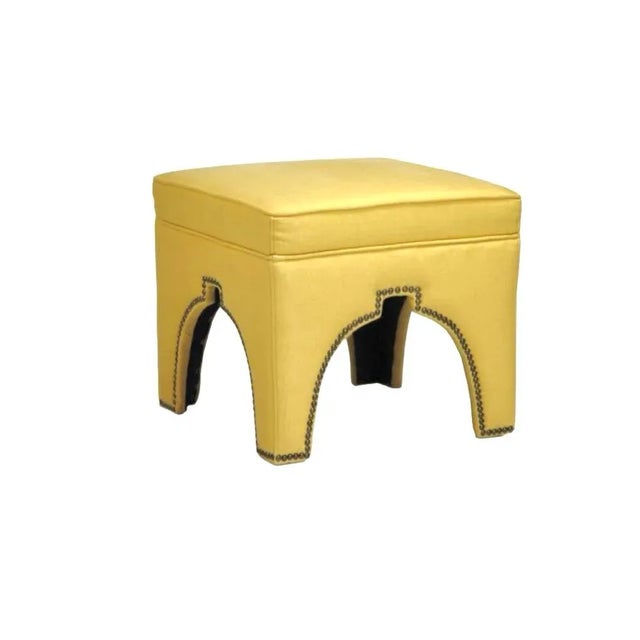 Designer square ottoman with brass nailhead trim. Works as footstool, extra seat, or coffee-table companion. Condition:...