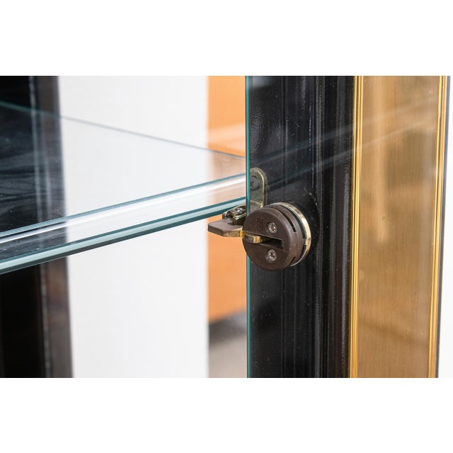 A vintage Mastercraft brass and glass shelving unit. This beautiful etagere/shelving unit features a solid brass and glass...