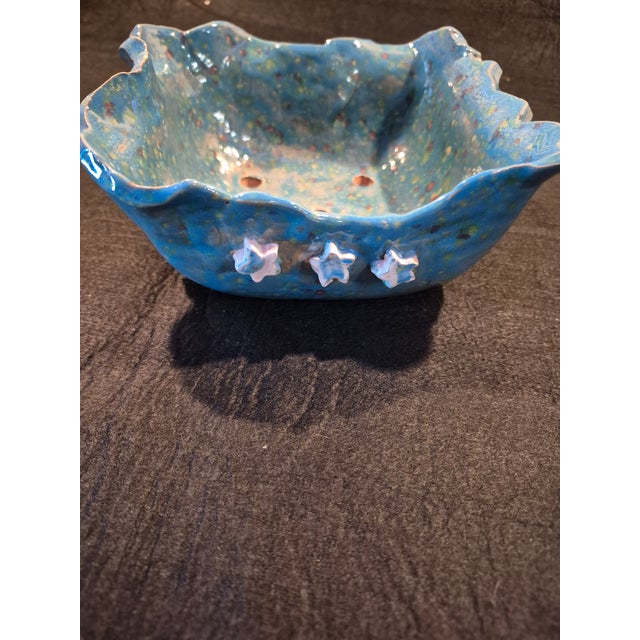 This is a hand-built, square-shaped bonsai bowl featuring a vibrant cerulean blue glaze with multi-colored speckles. Key...