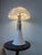 This iconic medium-sized table lamp from the celebrated Pipistrello series, designed in 1965 by Gae Aulenti for Martinelli...