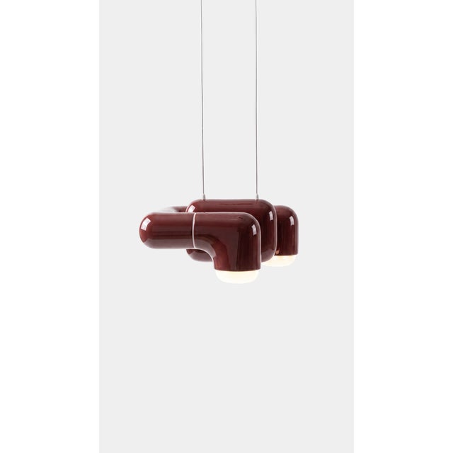A pendant light with real character in a small footprint. Curved printed tiles interlock into a low, wide shade that seems...
