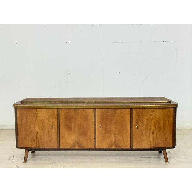 This exclusive vintage sideboard is a true gem for lovers of classic elegance and high-quality craftsmanship. The piece...