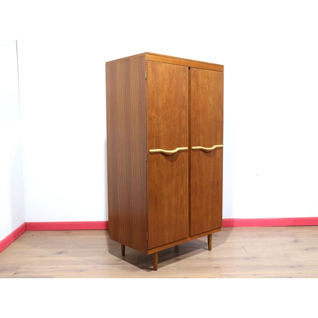 This Mid Century Modern Vintage Teak Double Armoire Wardrobe by Stonehill Danish Style is a design classic that perfectly...