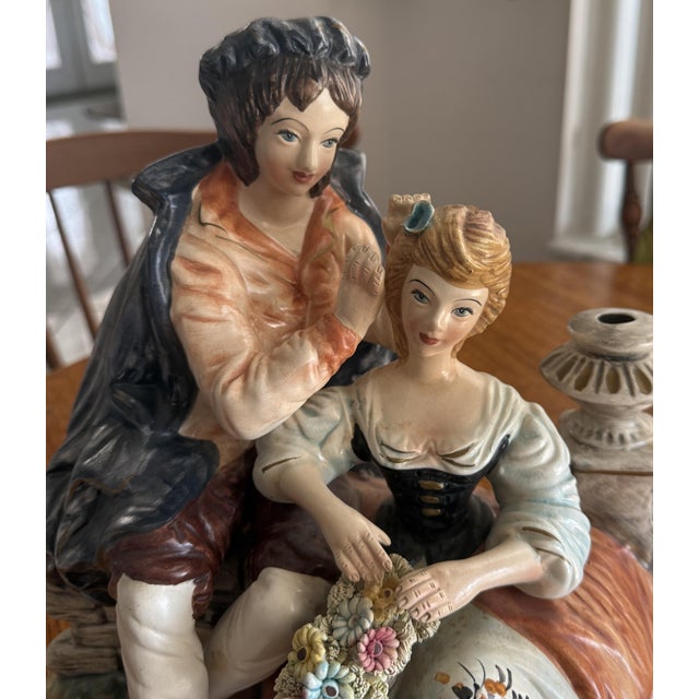 Beautiful vintage Capodimonte porcelain figurine depicting a romantic Victorian couple in an elegant courtship scene. The...