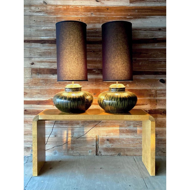 Pair of vintage modern monumental table lamps in black and gold ceramic. A rare find! This pair of modern lamps have a...