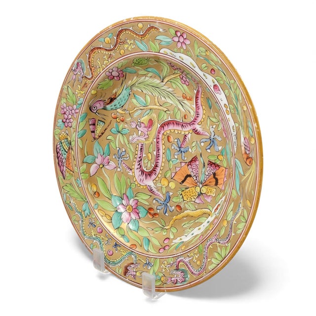 An expressive early mason chinoiserie plate with a rich ochre ground and bold enamel decoration. A serpentine dragon,...