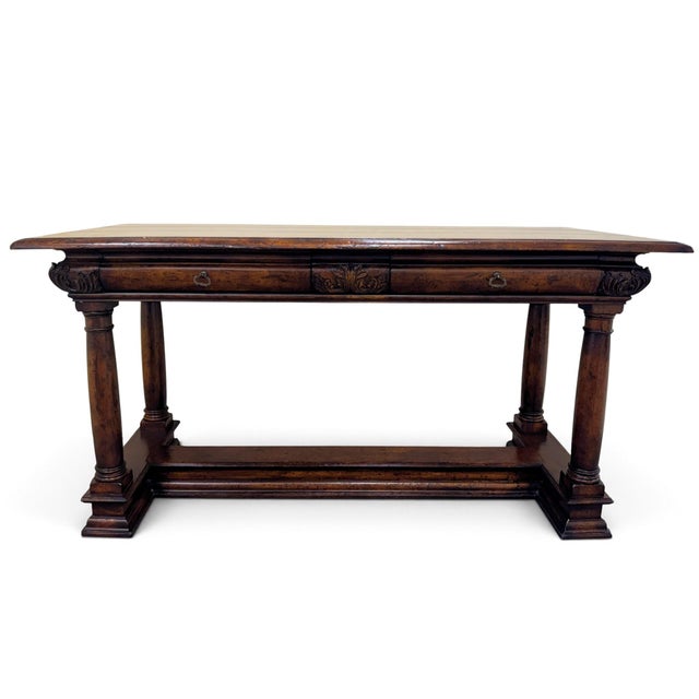 John Richard European Crossroads library table or console table. Features a striking faux-plank tabletop with an...