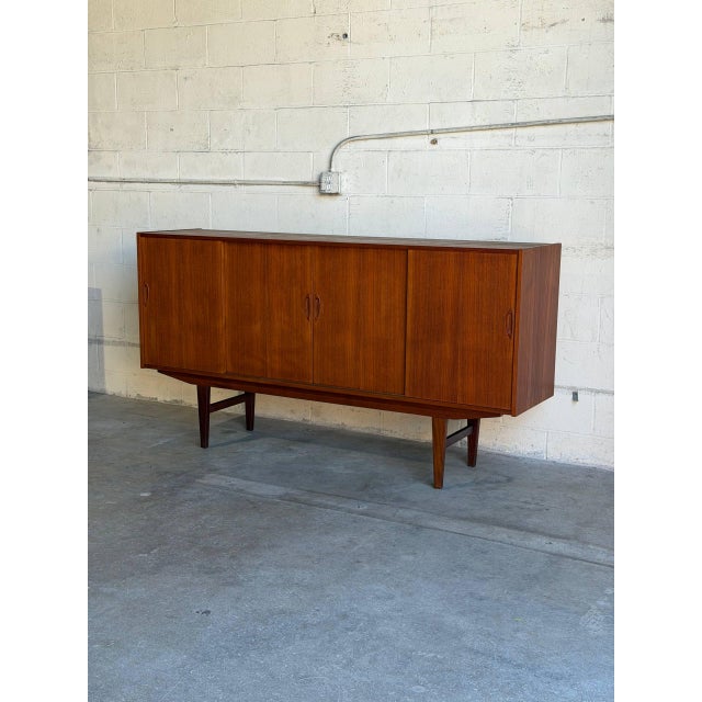 Beautiful vintage Danish modern sideboard crafted in richly grained teak with clean Scandinavian lines and elegant tapered...