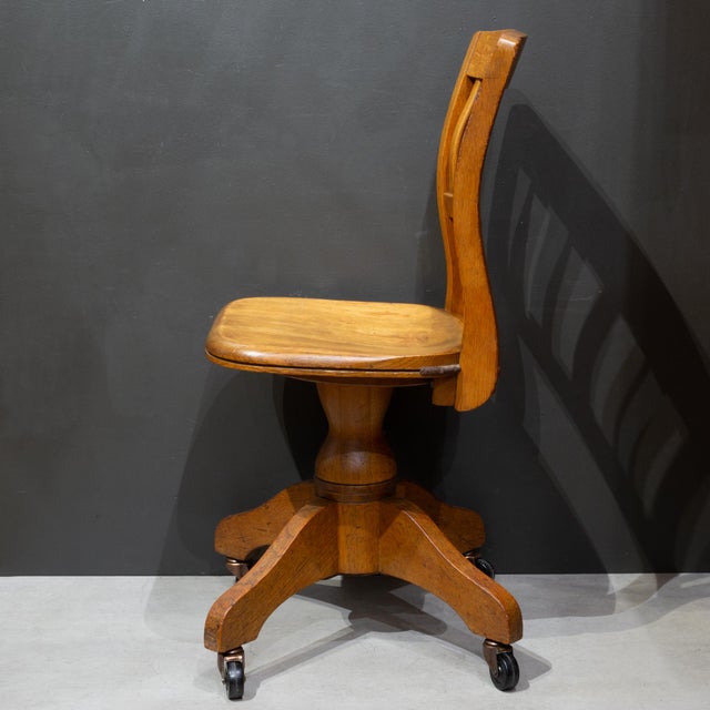 ABOUT A solid Oak typist or stenographer's swivel office chair with curved legs, sculpted seat and curved backrest....