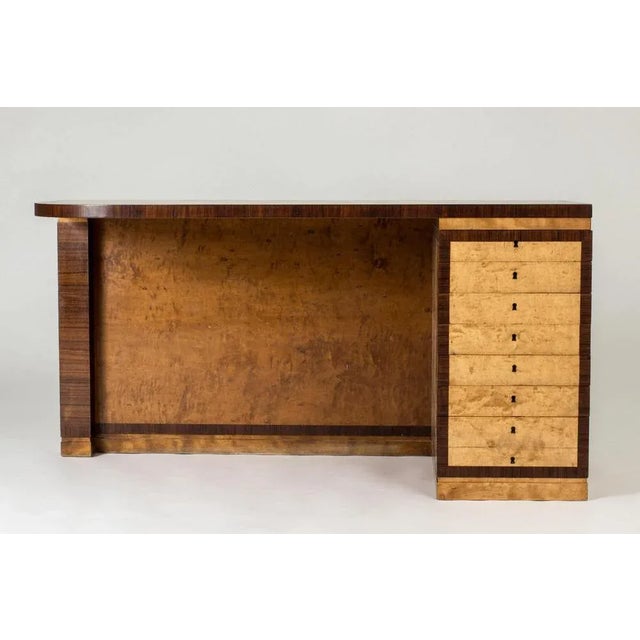 Luxurious “Record” desk by Axel Einar Hjorth, with birch root top and sides and framed with contrasting zebrano....