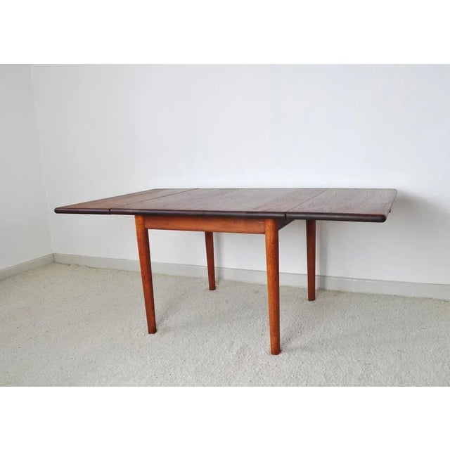 Side or coffee table designed by Hans J. Wegner for GETAMA, Denmark. Top in solid teak with two drop leaves. Frame and...