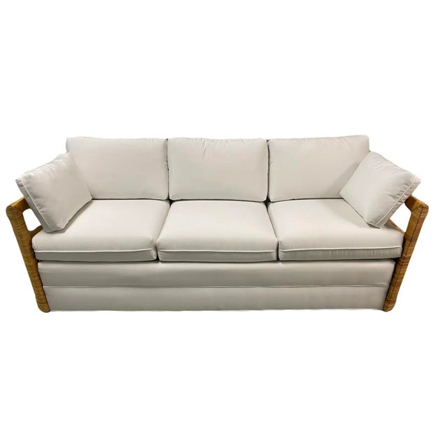 Crespi style split reed radius arm shaped sofa. Rattan arms with interior wicker sides. Newly upholstered in a white...