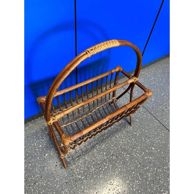 Mid Century modern rattan magazine rack in rich brown with lighter woven accents.