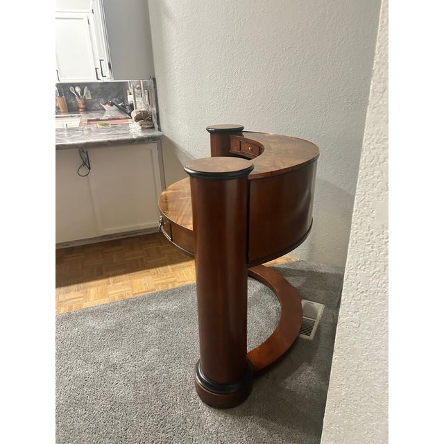 Century Furniture Neoclassical Demi-Lune Console Table in a warm mahogany/cherry finish with ebony trim accents and brass...