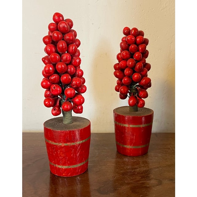 Pair antique early 20th c. German Christmas ornaments in the form of topiary berry trees in carved wood pots with gilt...