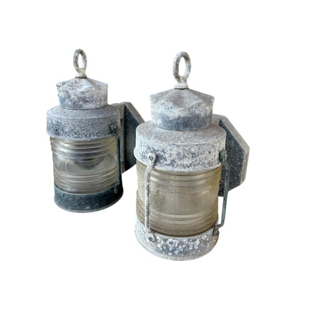 A pair of nautical wall mounted masthead lanterns circa 1960. Made of cast aluminum with rich patina, ribbed glass...