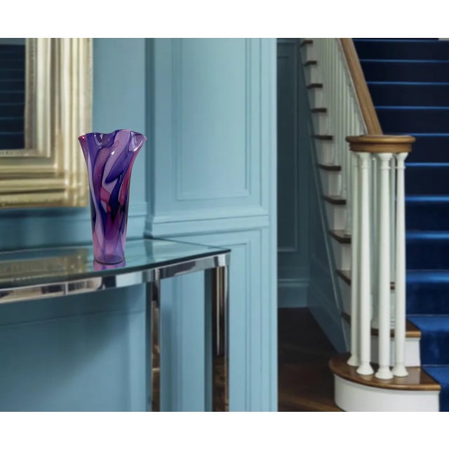 A striking hand-blown Studio art glass vase featuring a dramatic freeform ruffled rim and richly layered swirls of...