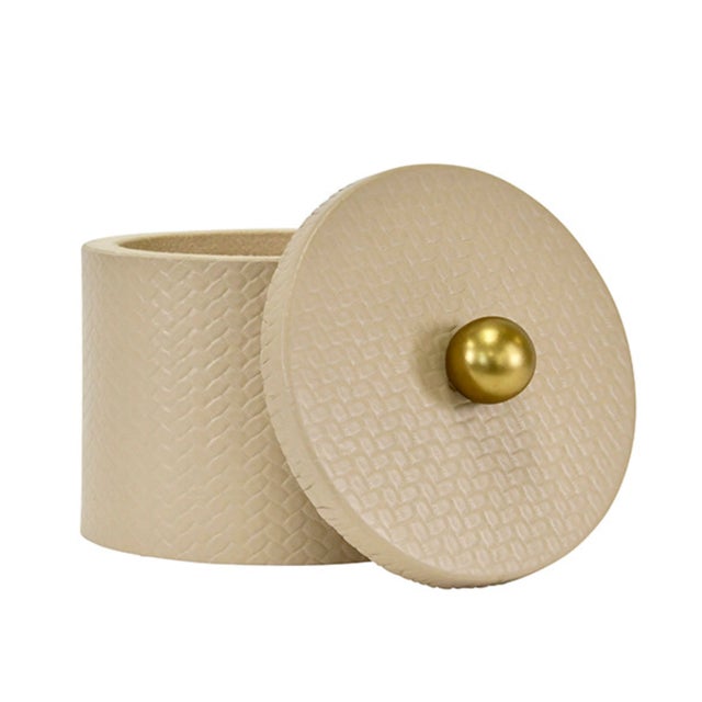 New item. Not vintage. Lovely, round ivory faux leather container with lid and brass ball handle. A great bathroom,...