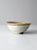 This vintage studio pottery bowl features a soft white glaze accented by a dipped tan rim, creating a subtle contrast in...
