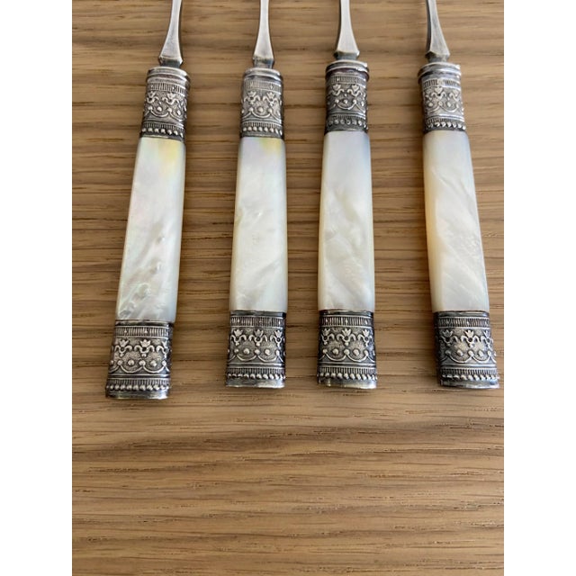 This set includes four Vintage Nut Picks with mother of pearl handles and silverplate ferrules. The ferrules are intricate...